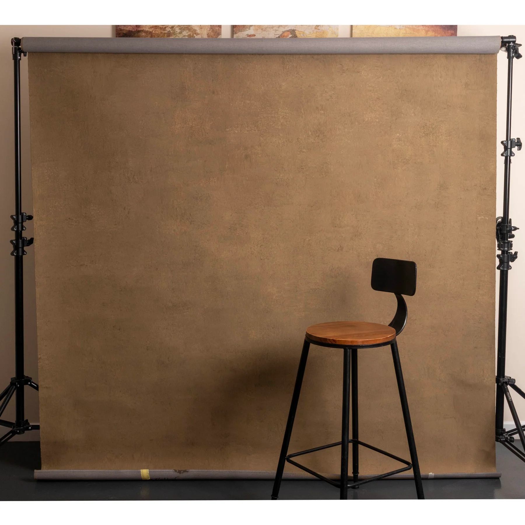 Hand-painted canvas installed on a background support with a studio chair