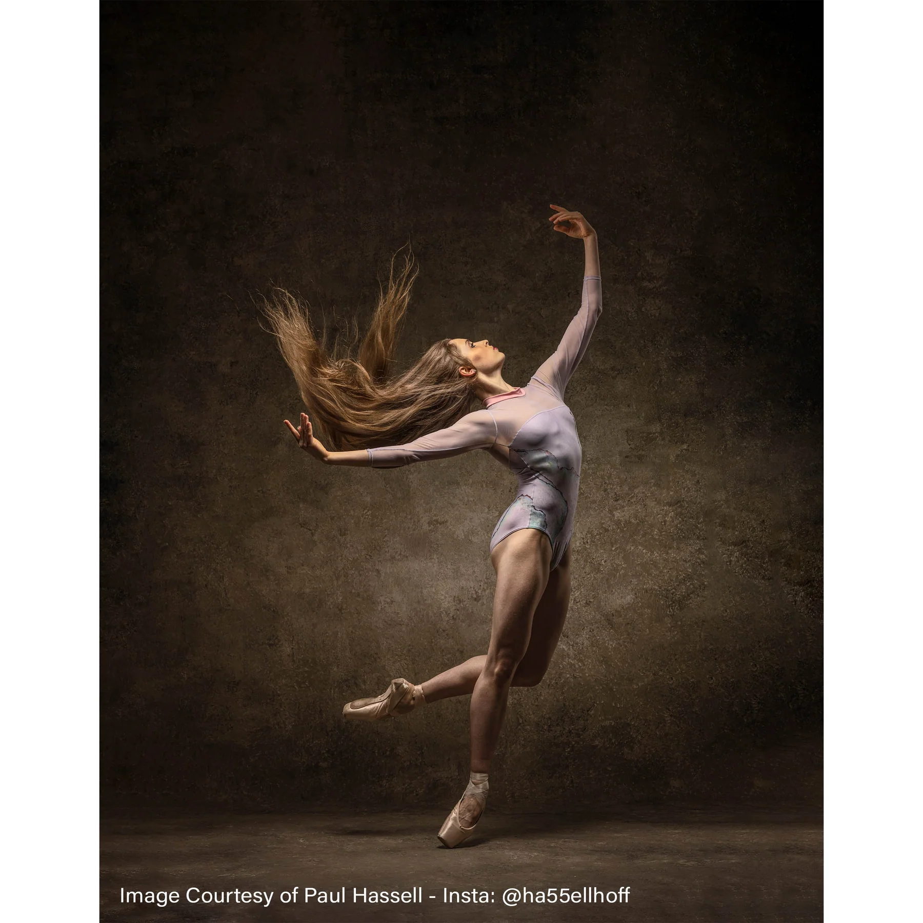 Dancer photographed against a dark hand-painted backdrop